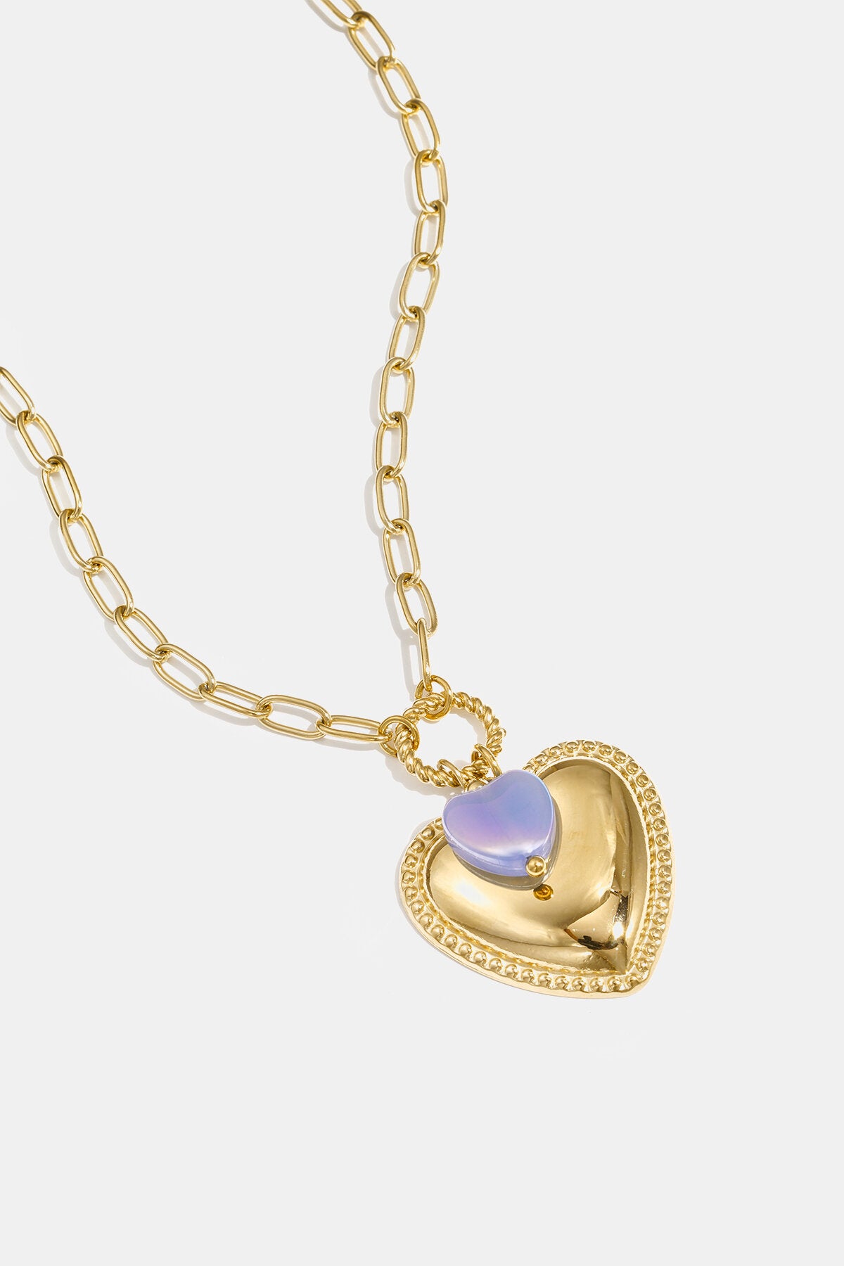 Necklace with heart pendant and bead on ring